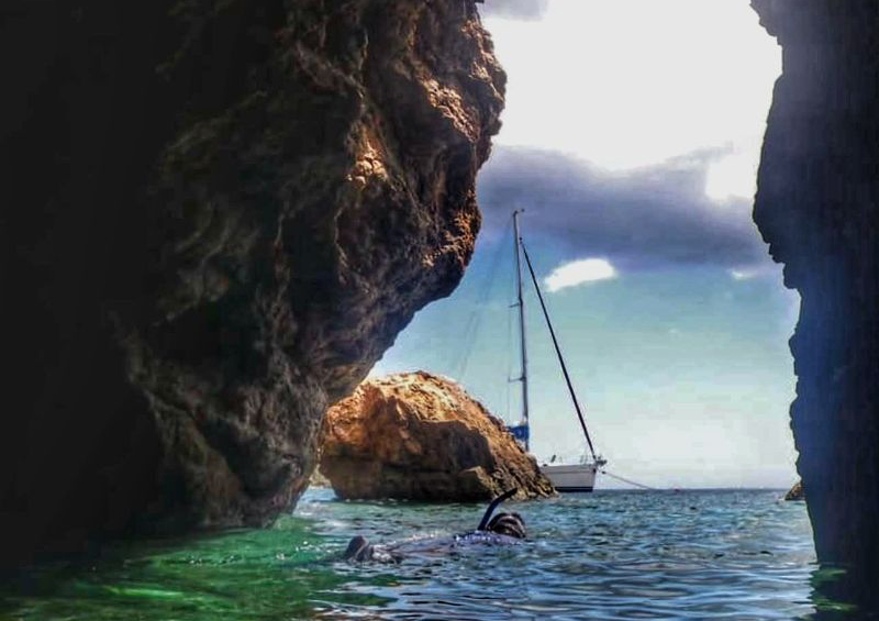The Caves, Norman Island, BVI Snorkeling in The Caves on Norman Island in the BVIs with a charter yacht in the background